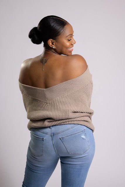 Model wearing a cozy balloon sleeve V-neck waffle sweater in ash mocha, a warm and neutral shade